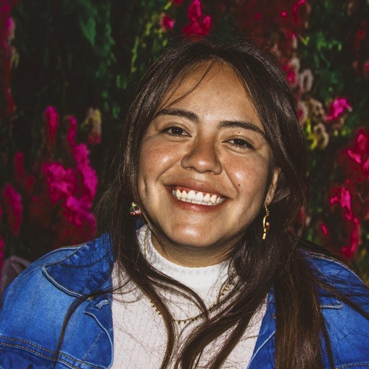 Kaveri Mehta, Lead Design Curator at Harbor Lane Haven, reviewing corporate floral arrangements